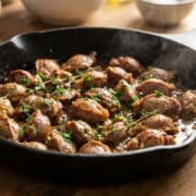 sizzling golden gizzards in cast iron pan