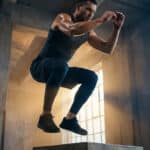 Bruce Lee demonstrating explosive strength and functional fitness training techniques